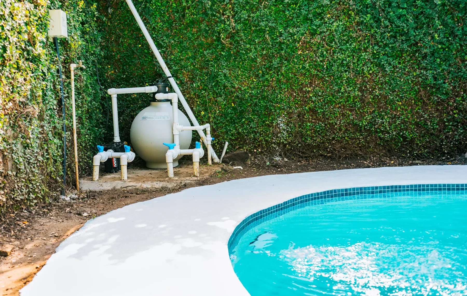 A residential pool pump and filter equipment pad, the kind of hardware behind most pool repair calls